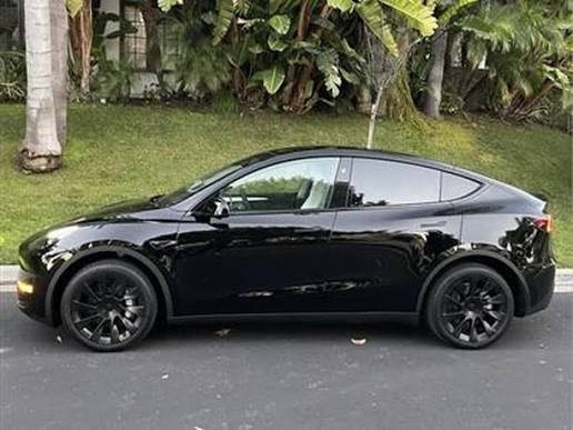 2024 Model Y Long Range AWD in Solid Black, side profile