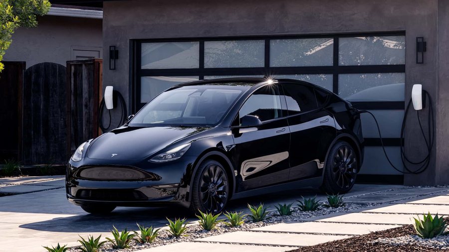 A Solid Black Model Y on a home charger